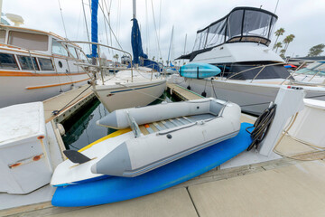 Fototapeta premium Inflatable boat at the concrete dock in a harbor at Oceanside, California