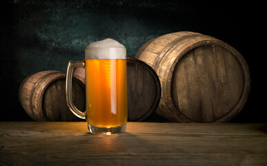 Glass of light beer on a dark pub.