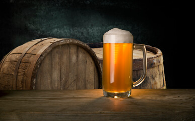 Glass of light beer on a dark pub.