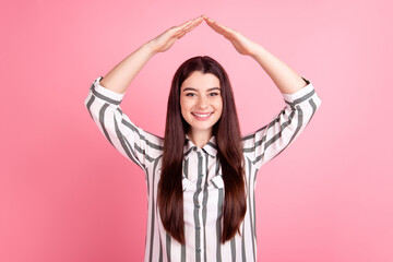 Photo of cheerful lady hold hands above head new house real estate relocation isolated over pink color background