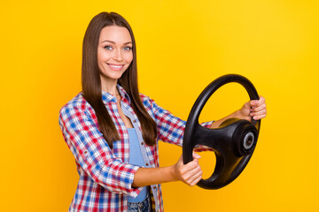 Photo of responsible confident lady hold steering wheel prepare trip wear plaid shirt isolated yellow color background