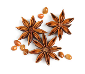 Dry anise stars with seeds on white background, top view