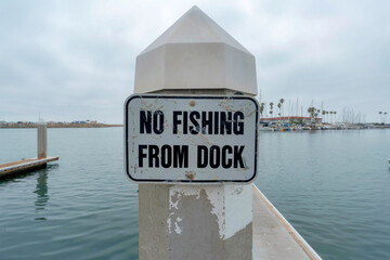 No fishing from dock old signage at Oceanside, California