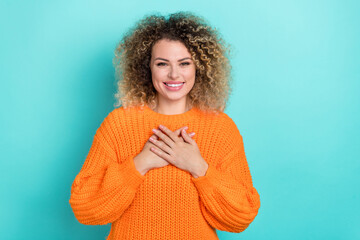 Photo of grateful sincere lady hands chest show appreciation wear orange knitted pullover isolated teal color background
