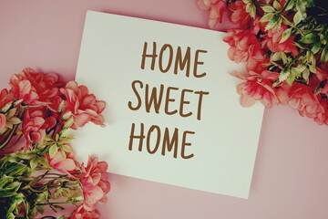 Home Sweet Home typography text with flowers on pink background
