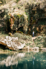 Woman enjoys nature life in Anento waterfall, a lovely spanish town in Aragon. Isolated location perfect for forest bathing or meditation. Concept: holidays