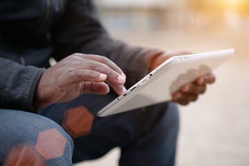 African american man uses tablet computer. Black mans hands holds a tablet pc