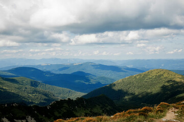 Incredibly beautiful panoramic views of the Carpathian Mountains. Peaks in the Carpathians on a background of blue sky