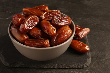 Tasty sweet dried dates on black table, closeup