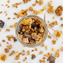 crunchy granola in jar isolated on white background