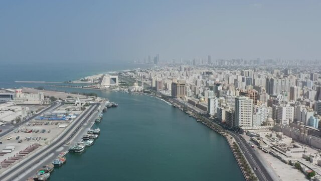Aerial view Sharjah UAE. Cityscape of the city with business centers and high-rise buildings on the shores of the Persian Gulf with a beautiful seascape.