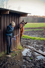 horse and girl afraid of stepping in dirt - obrazy, fototapety, plakaty