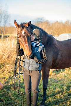 girl kising horse after training