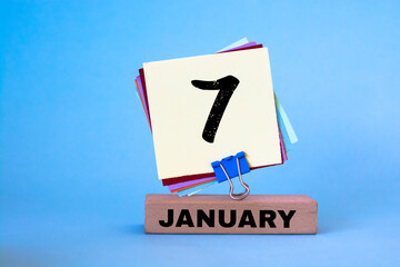 January 7th. Day 7 of month, calendar on blue background. Winter time.