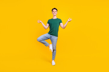 Fototapeta na wymiar Full body photo of charming positive calm man asana yoga good mood isolated on yellow color background