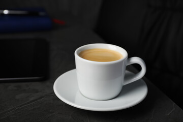 Coffee Break at workplace. Cup of hot espresso on grey table