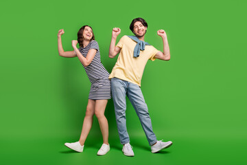 Full length photo of young excited couple happy positive smile dance party isolated over green color background