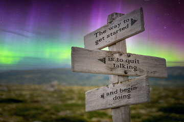 the way to get started text quote on signpost under the northern lights.