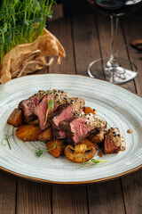 Gourmet beef medallions dish with potatoes and mushrooms