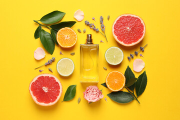 Flat lay composition with bottle of perfume and fresh citrus fruits on yellow background - obrazy, fototapety, plakaty
