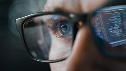 Close-up Portrait of Software Engineer Working on Computer, Line of Code Reflecting in Glasses. Developer Working on Innovative e-Commerce Application using Machine Learning, AI Algorithm, Big Data - obrazy, fototapety, plakaty
