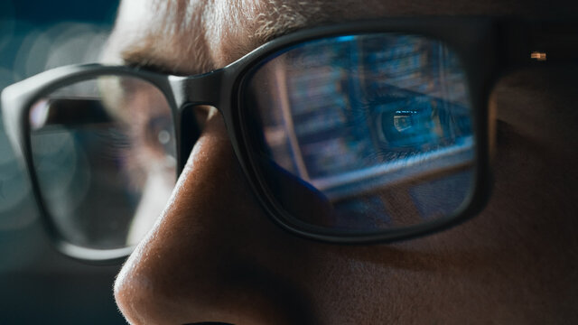 Close-up Portrait of Software Engineer Working on Computer, Line of Code Reflecting in Glasses. Developer Working on Innovative e-Commerce Application using Machine Learning, AI Algorithm, Big Data