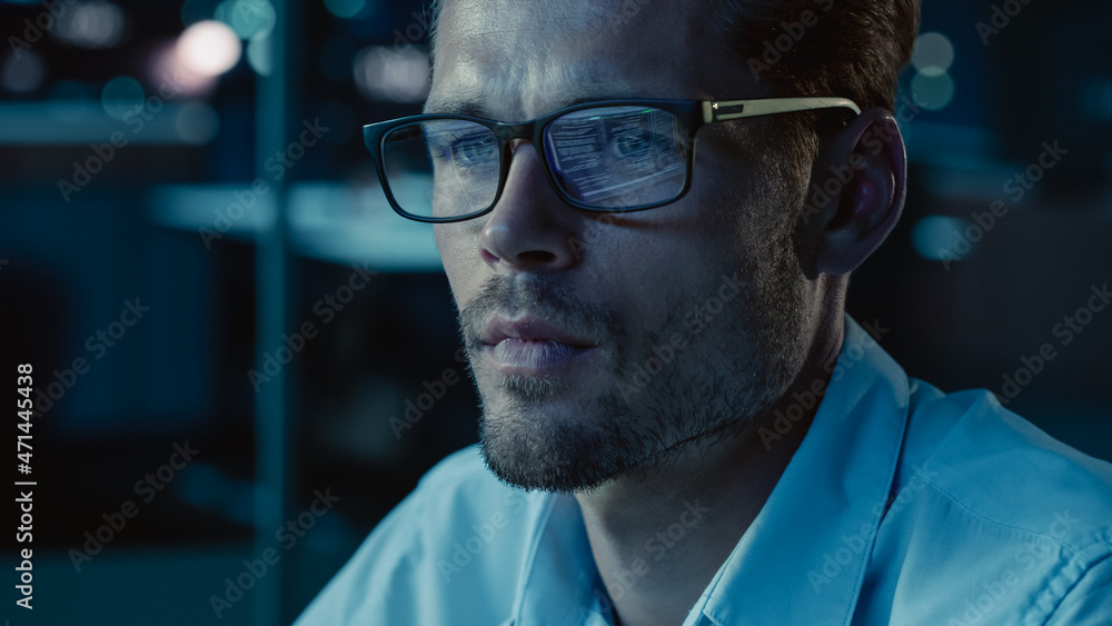 Leinwandbilder At Night Portrait of Handsome Startup Digital Entrepreneur Working on Computer, Line of Code Reflecting in Glasses. Developer Working on Innovative e-Commerce App using AI Algorithm Big Data. Blue