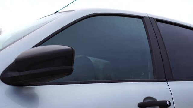 Automatic system of opening and closing glass of car. The window is closing
