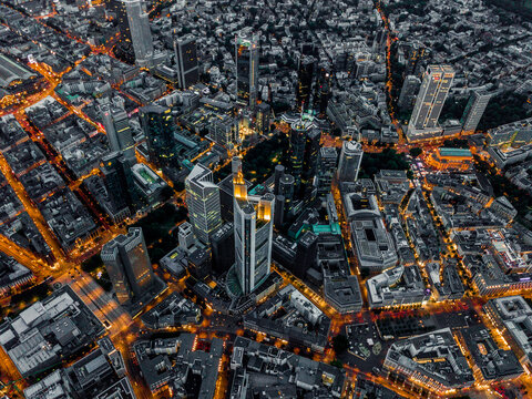 Aerial Overhead Shot Of Frankfurt Am Main, Germany Skyline At Night With Glowing Streets