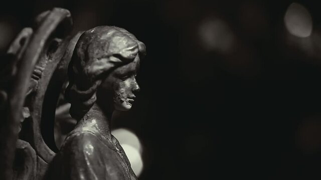footage of angel statue dark background