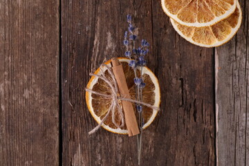 Fototapeta na wymiar Decor with dried oranges on a wooden background