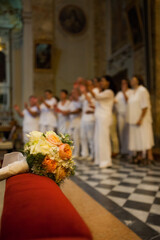 Bride bouquet on cushion with out of focus background Choir group perform in church in traditional wedding ceremony - 471450207