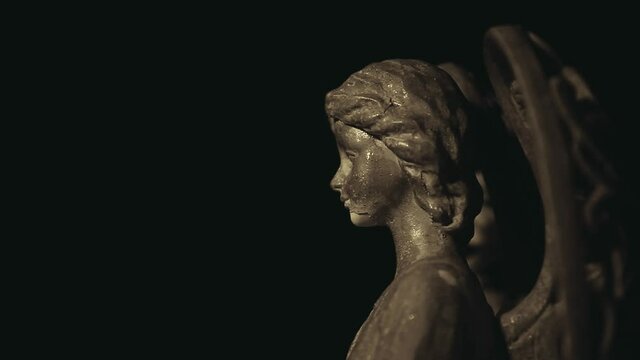 footage of angel statue dark background