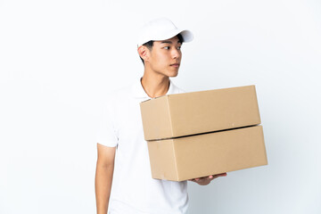 Delivery Chinese man isolated on white background looking to the side