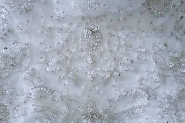 Macro, Close-Up white classical wedding Dress details and texture decorated with tiny crystals
