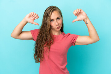 Fototapeta premium Young caucasian woman isolated on blue background proud and self-satisfied