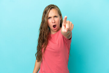 Fototapeta premium Young caucasian woman isolated on blue background frustrated and pointing to the front