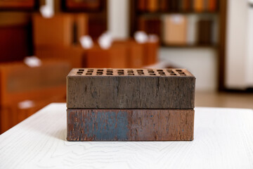 two brown bricks lie on a white table
