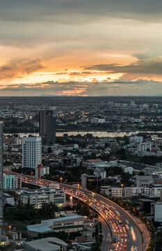 Bangkok, Thailand - Aug 30, 2021 : Gorgeous panorama scenic of the sunrise or sunset with cloud on the orange and blue sky over large metropolitan city in Bangkok. Copy space, Selective focus. © num