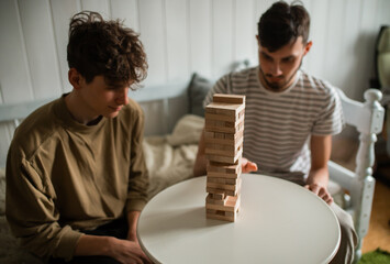 The hands of business men playing a game with wooden blocks. Conceptual risk management and strategic plans for business growth and success. 2 businessmen play a game with wooden blocks