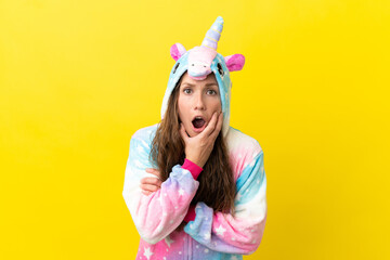 Girl with unicorn pajamas over isolated background surprised and shocked while looking right