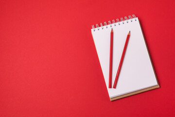 Blank Notepad and Red Pencil on Red Background Horizontal Copy Space Business Concept