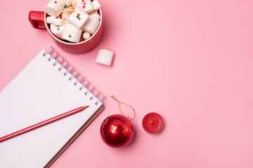 Holiday Christmas Background with Notepad Cup of Cocoa with Marshmallow and Red Pencils and Christmas Decoration Horizontal Copy Space