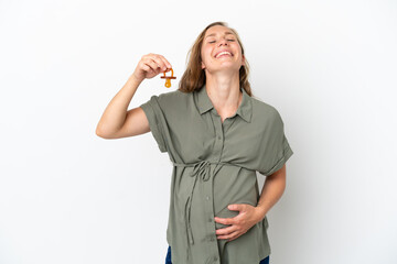 Young caucasian woman isolated on white background pregnant and holding a pacifier