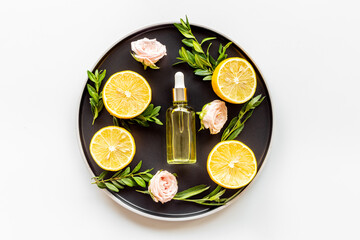 Fototapeta na wymiar Essential oil with herbs citrus and flowers. Organic cosmetic ingredients