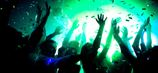 Photo of carefree bachelors fellows enjoy rejoice sound show disco floor raise hands up under...