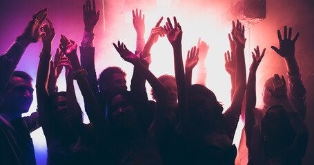 Photo of rejoice youngsters having corporate disco occasion dance raise hands up on discotheque...