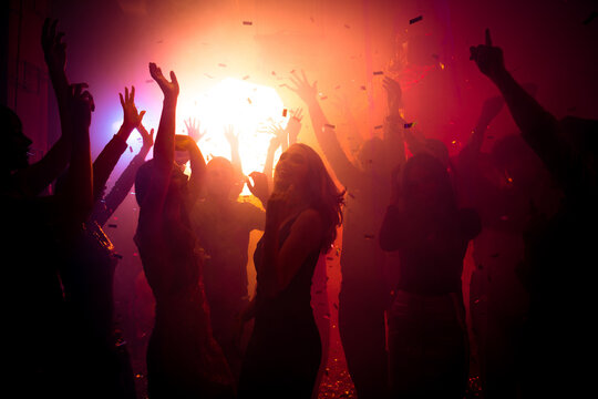 Photo of carefree lady friendship have corporate festival buddies on neon modern disco with flying confetti hands up