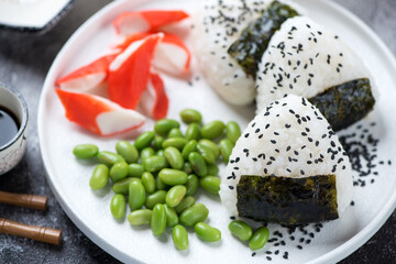 Onigiri or rice formed into triangular shapes and wrapped with nori, close-up, selective focus