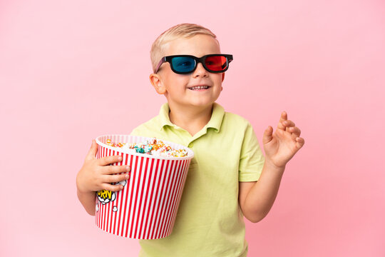 Little Russian boy eating popcorns in a big bowl over isolated background